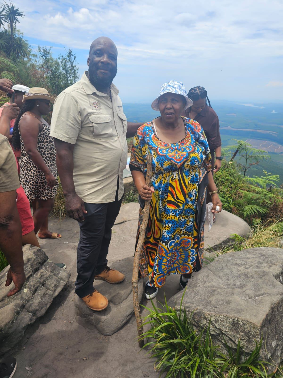 Guide with guests at mountain viewpoint